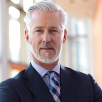 senior business man portrait portrait of senior business man with grey beard and hair alone i modern office indoors